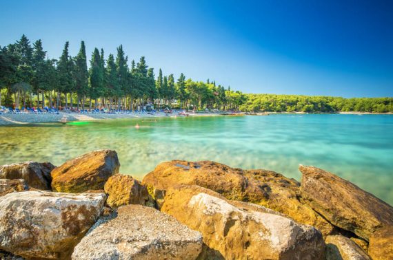 Beach in Supetar town on Brac island with turquoise clear water, Supetar, Brac, Croatia, Europe.
